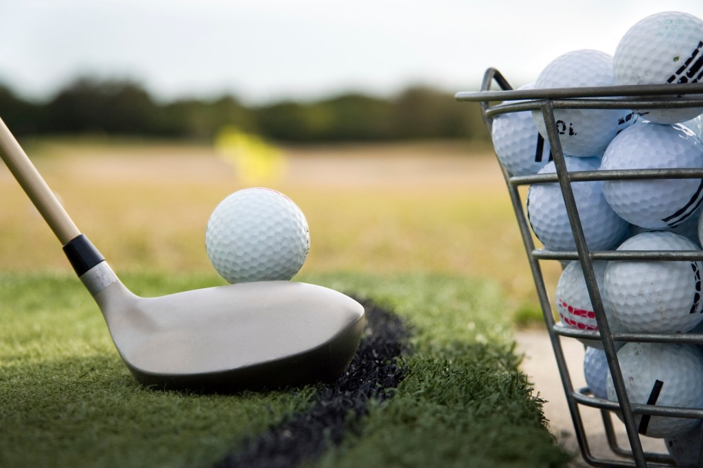 golfer lining up swing at the driving range